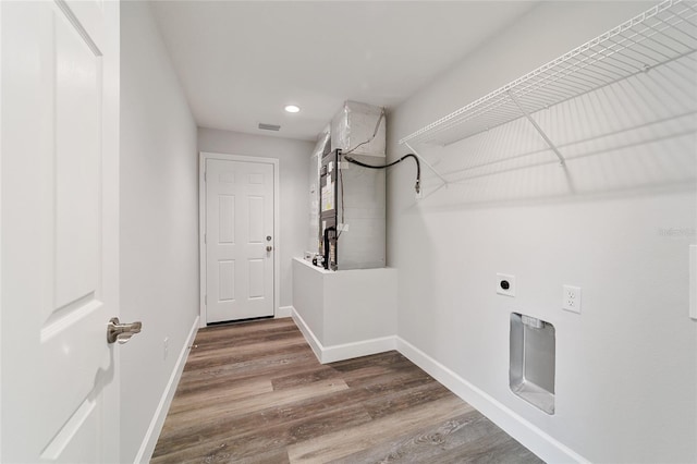 clothes washing area with hardwood / wood-style floors and hookup for an electric dryer