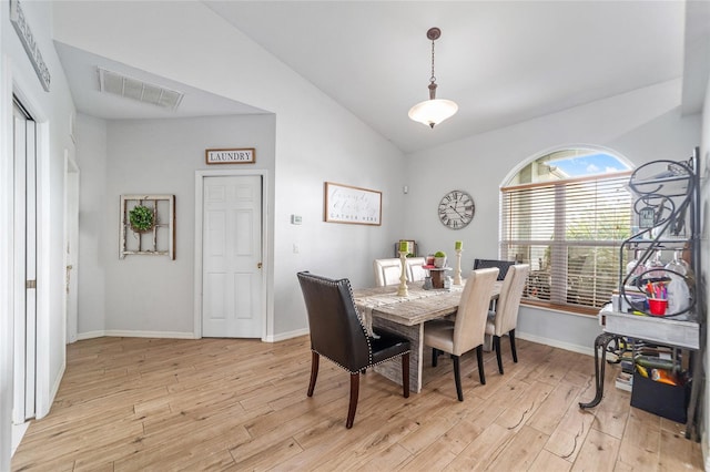 dining area featuring light hardwood / wood-style floors and vaulted ceiling