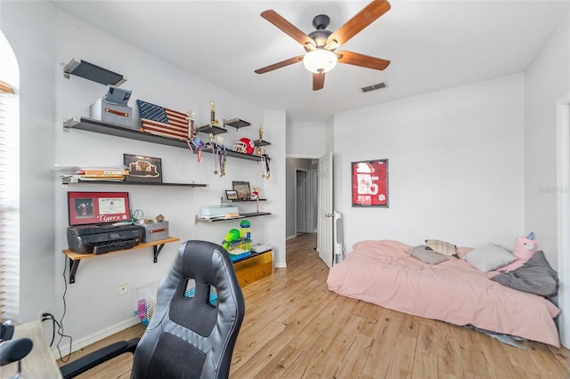 bedroom with ceiling fan and light hardwood / wood-style floors