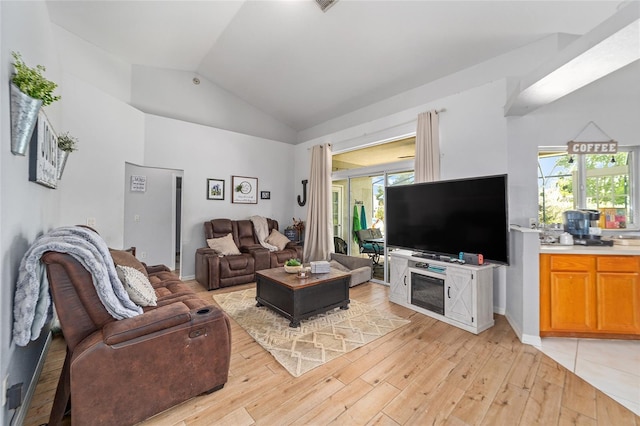 living room featuring light hardwood / wood-style floors and lofted ceiling