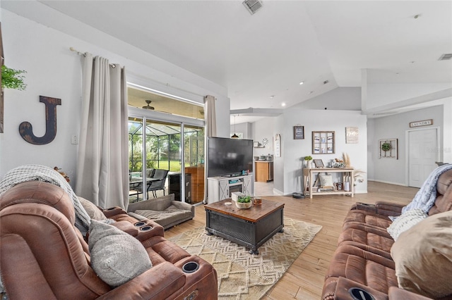 living room with light wood-type flooring and lofted ceiling