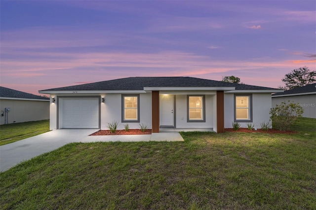 ranch-style home featuring an attached garage, a front lawn, concrete driveway, and stucco siding