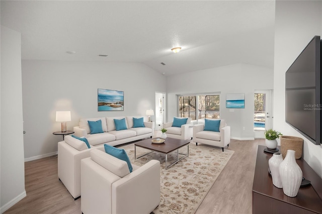 living room featuring light hardwood / wood-style floors and lofted ceiling