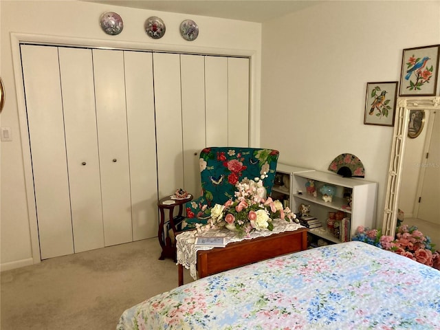 bedroom featuring light colored carpet and a closet