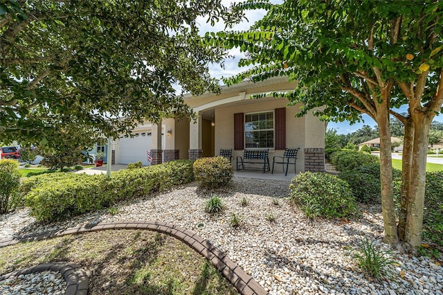 view of front of house with a porch and a garage