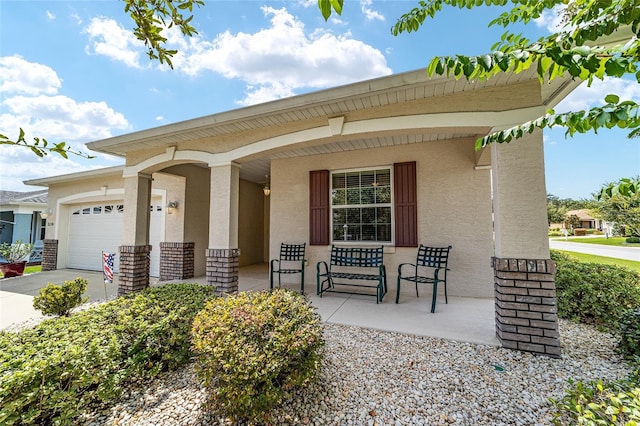 exterior space featuring a porch and a garage