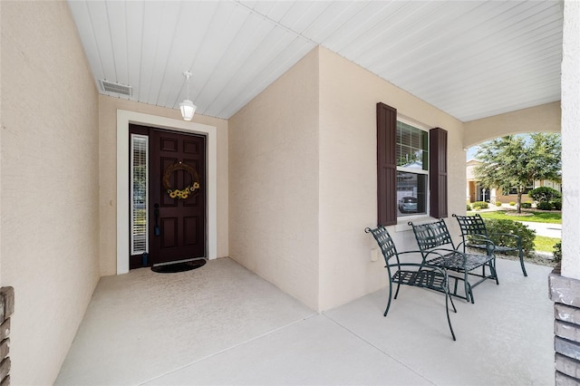 view of exterior entry featuring a porch