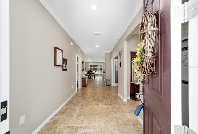 corridor featuring light tile patterned flooring and crown molding