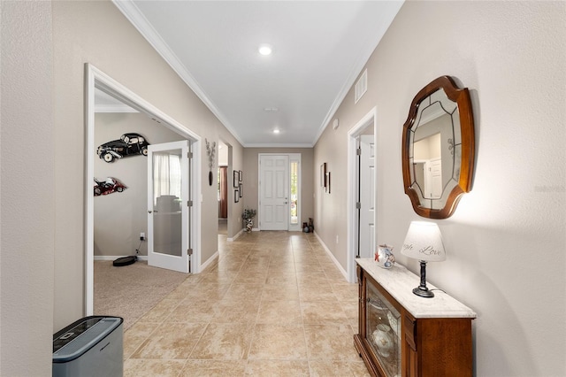 hall with ornamental molding and a wealth of natural light