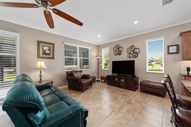 tiled living room featuring crown molding, ceiling fan, and a textured ceiling