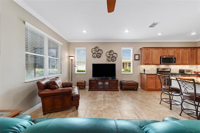 tiled living room featuring ceiling fan and ornamental molding