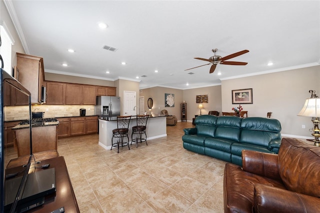 tiled living room featuring ceiling fan, sink, and crown molding