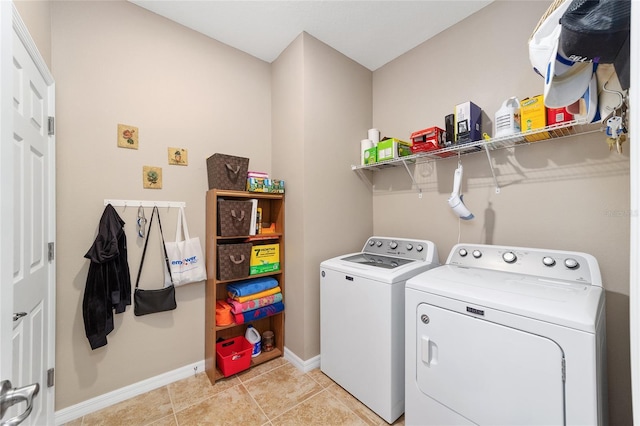 washroom featuring light tile patterned flooring and washer and dryer