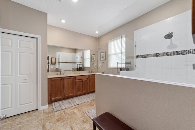 kitchen featuring kitchen peninsula, sink, and light tile patterned flooring