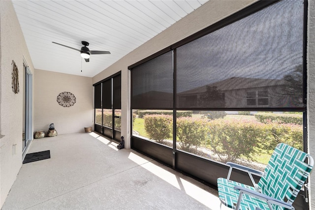 unfurnished sunroom featuring ceiling fan