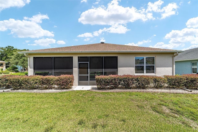 back of property featuring a lawn