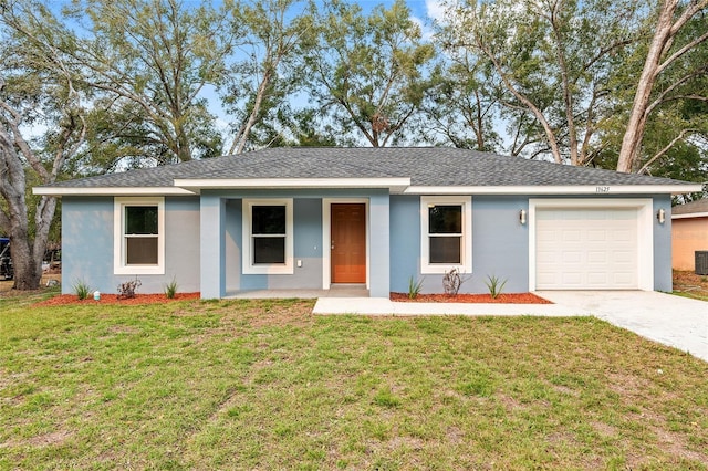 ranch-style home with concrete driveway, stucco siding, an attached garage, and a front yard