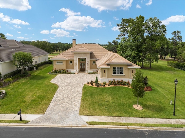 mediterranean / spanish house with cooling unit and a front yard