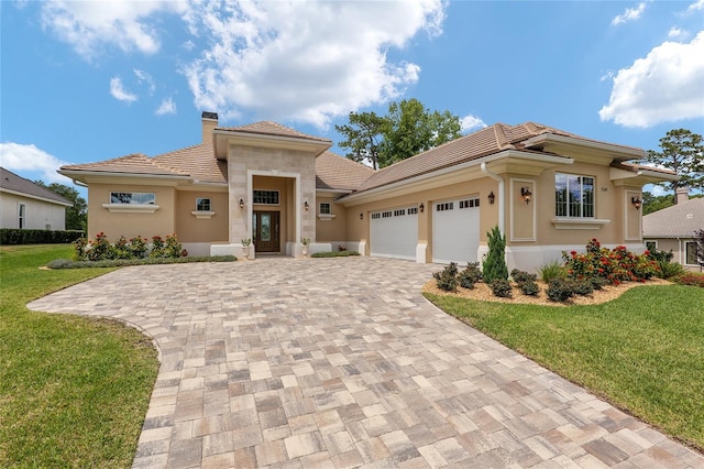 view of front of house with a garage and a front yard