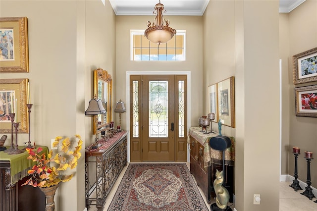 entryway with a towering ceiling and ornamental molding