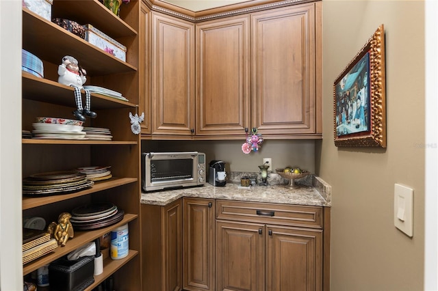 bar featuring light stone countertops