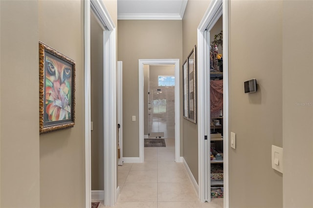 corridor featuring light tile patterned floors and ornamental molding