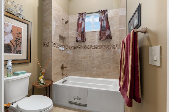 bathroom with tiled shower / bath combo and toilet