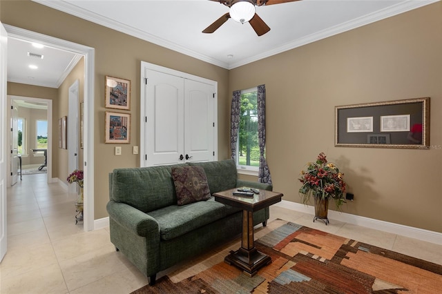 living room with crown molding, light tile patterned floors, and ceiling fan