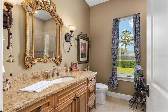 bathroom featuring tile patterned floors, vanity, and toilet