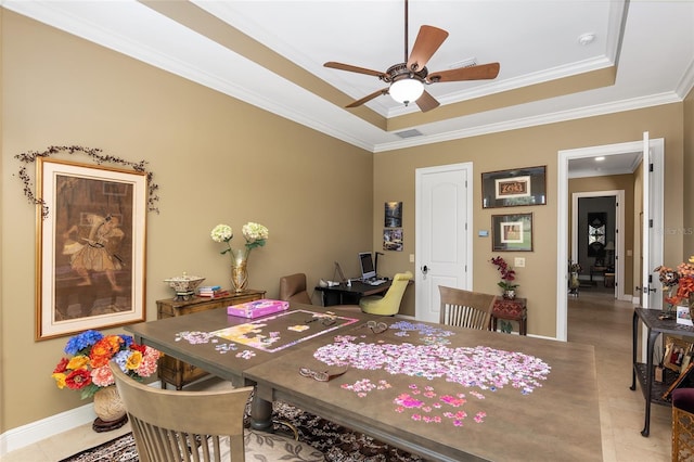 dining room featuring a tray ceiling, ceiling fan, and ornamental molding