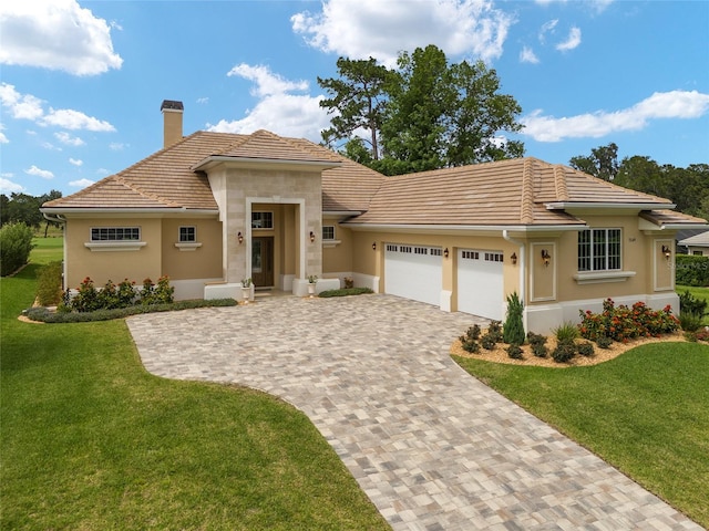 view of front of home with a front yard and a garage