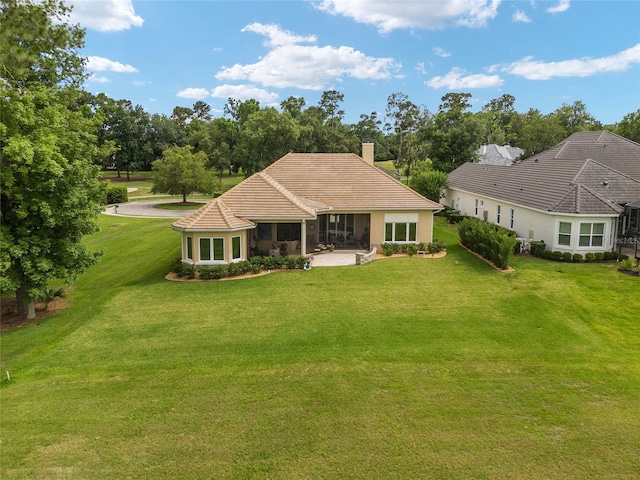 back of property featuring a yard and a patio area