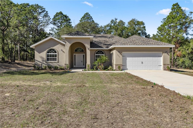 ranch-style home featuring a garage and a front lawn