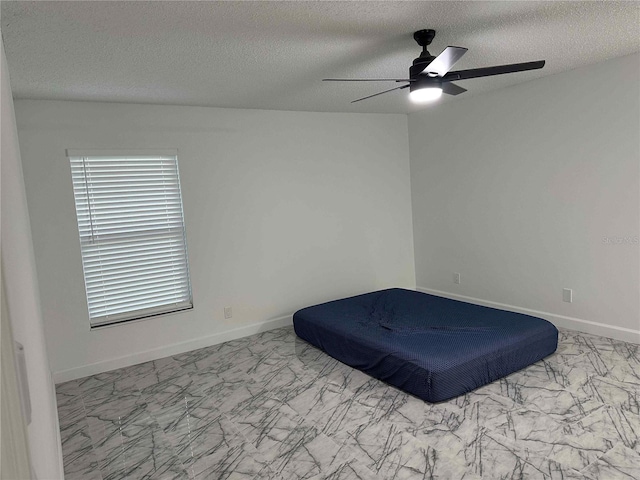 bedroom featuring a textured ceiling and ceiling fan