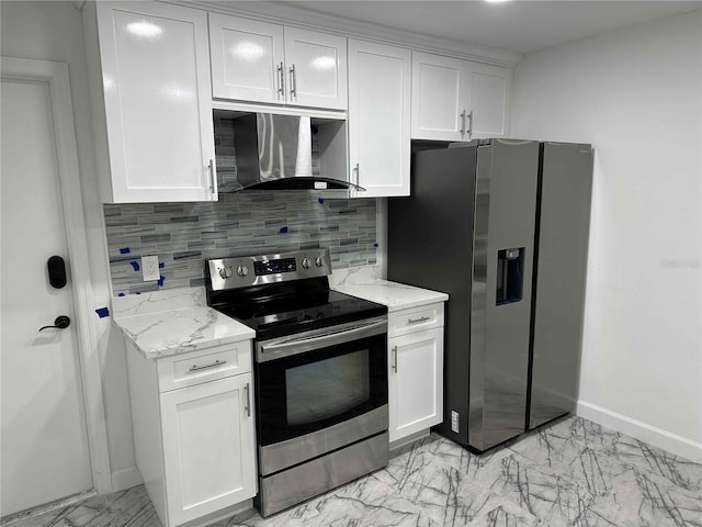 kitchen with wall chimney range hood, white cabinetry, stainless steel appliances, light stone countertops, and decorative backsplash