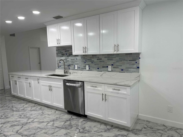 kitchen with sink, light stone counters, white cabinets, decorative backsplash, and stainless steel dishwasher