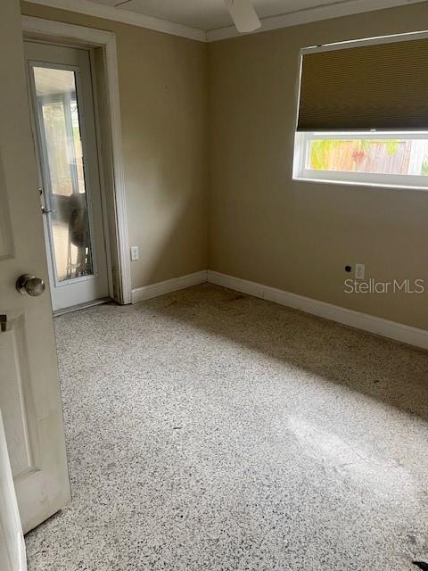 empty room featuring crown molding