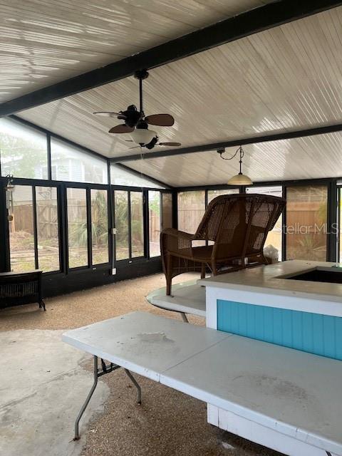 view of patio featuring ceiling fan and exterior bar