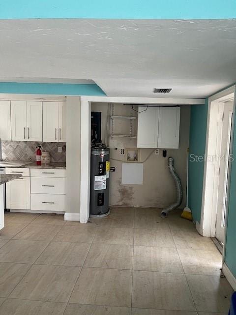 kitchen featuring white cabinets and electric water heater