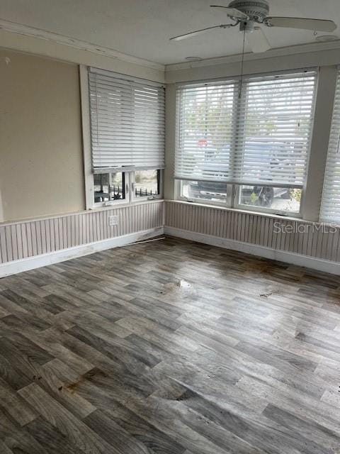 unfurnished sunroom with ceiling fan