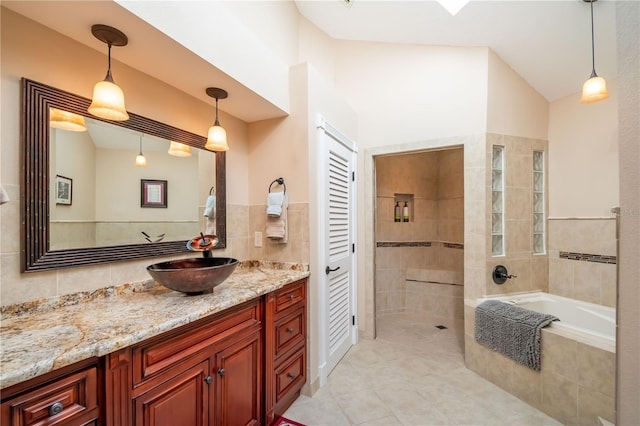 bathroom with tile patterned floors, vanity, independent shower and bath, and vaulted ceiling