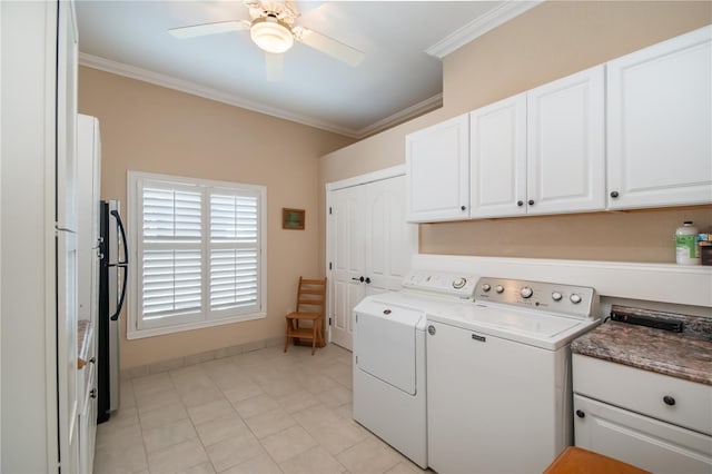 laundry room featuring light tile patterned floors, crown molding, ceiling fan, cabinets, and separate washer and dryer