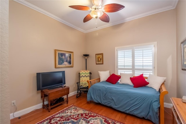 bedroom featuring ceiling fan, ornamental molding, and light wood-type flooring