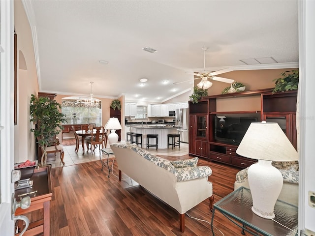 living room with ceiling fan, ornamental molding, lofted ceiling, and dark hardwood / wood-style flooring