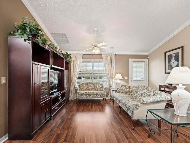 living room featuring a textured ceiling, dark wood-type flooring, crown molding, and ceiling fan