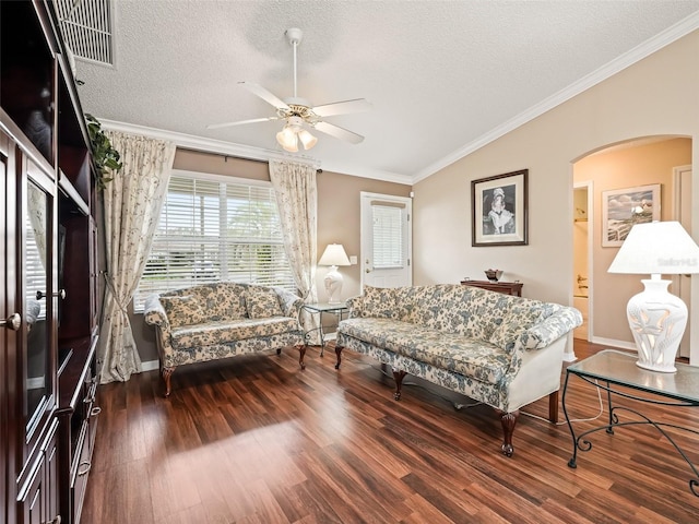 living room featuring wood-type flooring, a textured ceiling, ornamental molding, and ceiling fan