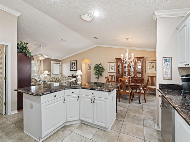 kitchen with lofted ceiling, dishwasher, a kitchen island, hanging light fixtures, and white cabinets