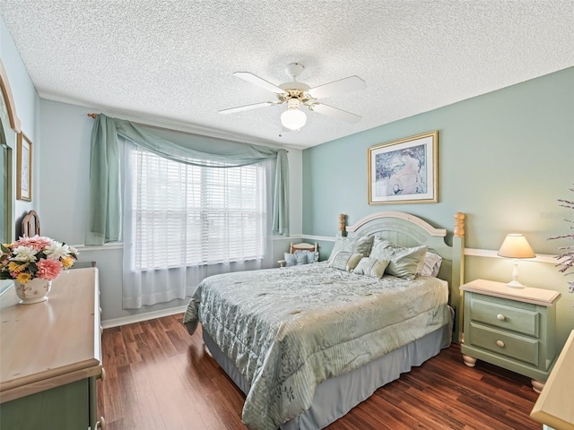 bedroom featuring ceiling fan, dark wood-type flooring, and a textured ceiling