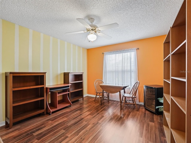 interior space with ceiling fan, dark wood-type flooring, and a textured ceiling