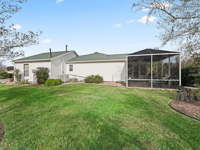 back of property featuring central AC unit and a yard